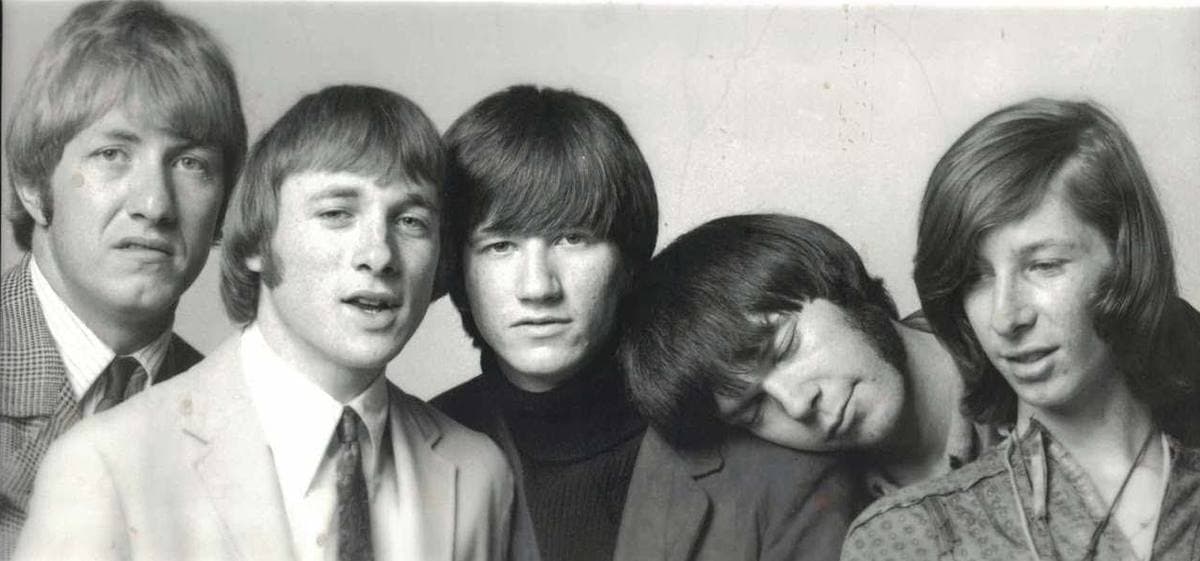 Black-and-white studio portrait of the five members of Buffalo Springfield, heads close together