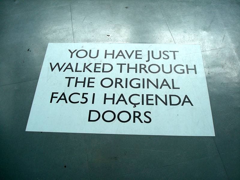 A floor sign that says you have just walked through the original FAC51 Haçienda doors