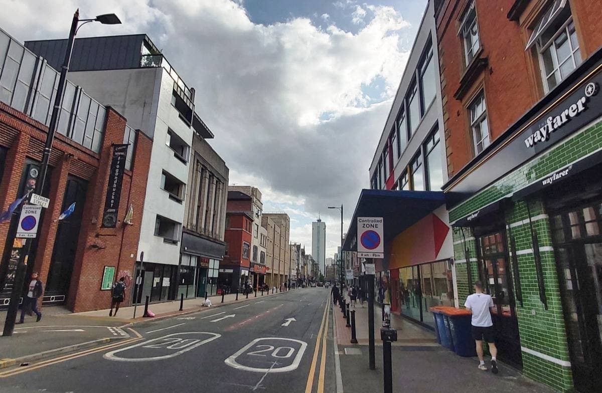 A busy city street of brick shopfronts
