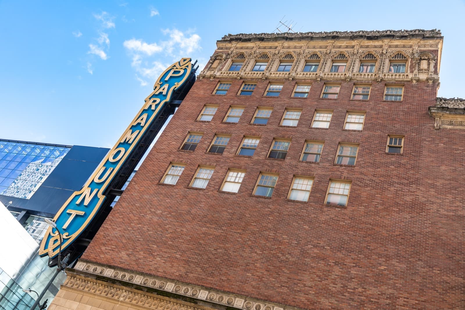 The brick front and vertical sign of the Paramount Theatre on a Seattle street