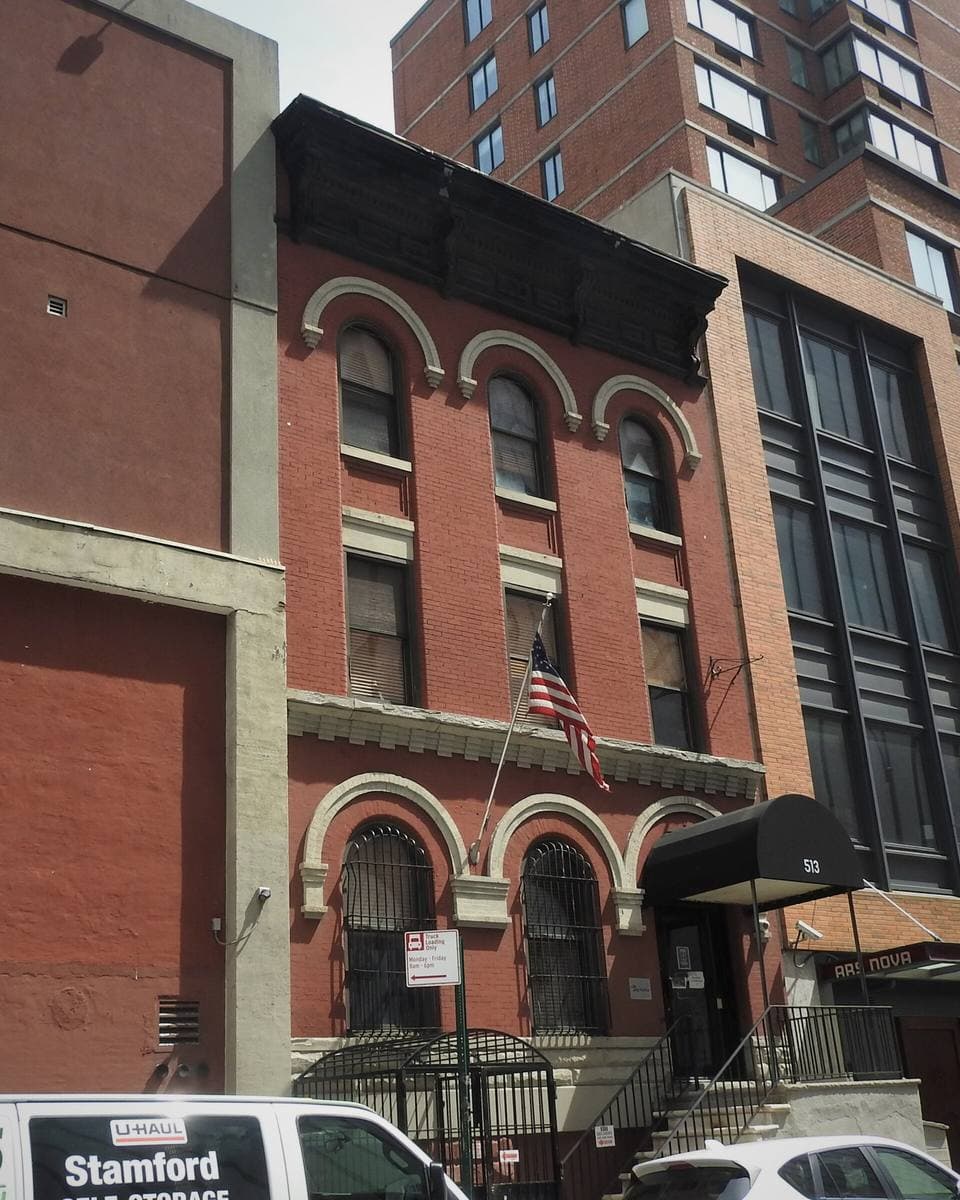 Red-brick row houses and a tower block on West 54th Street