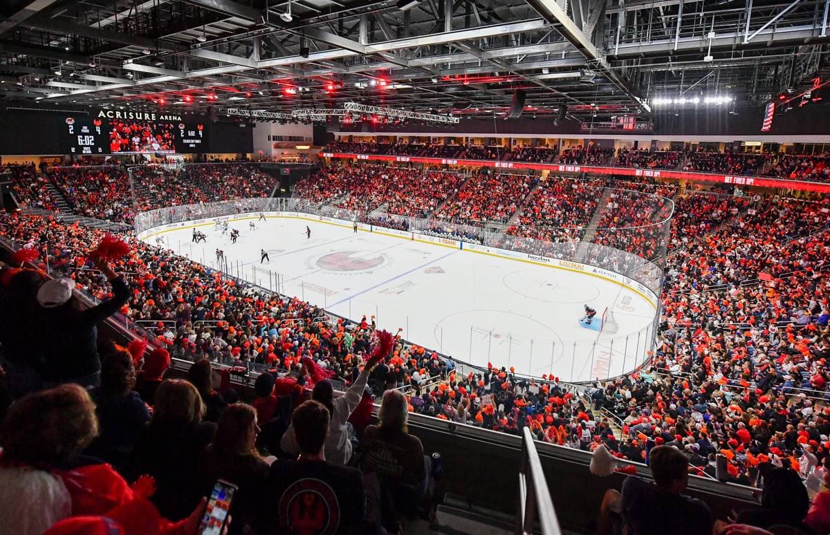 The bowl of Acrisure Arena full of people during a hockey game
