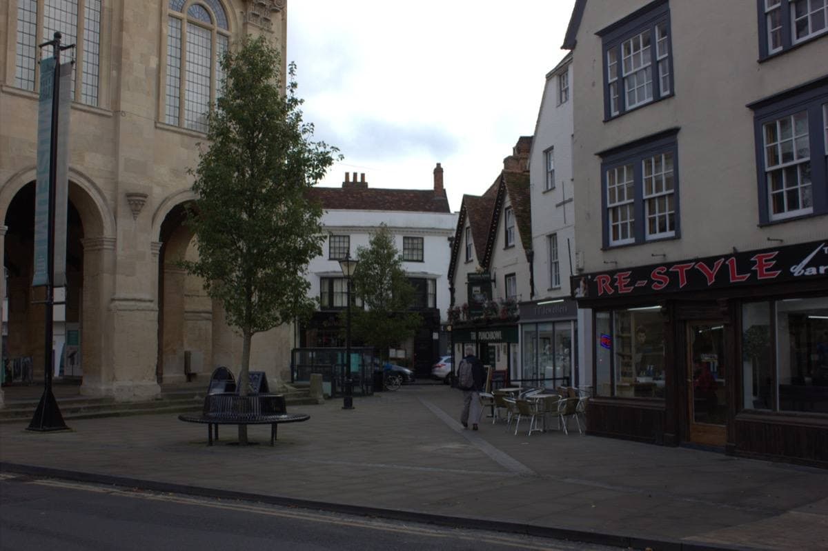 A market square in front of a tall seventeenth-century stone hall on arches