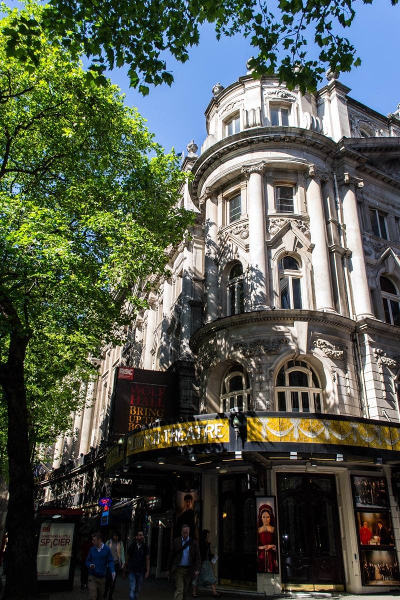 The corner front of a West End theatre on a curving street