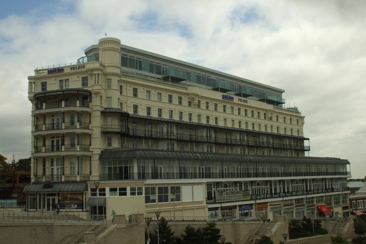 A large Edwardian hotel with a long balconied front above a road