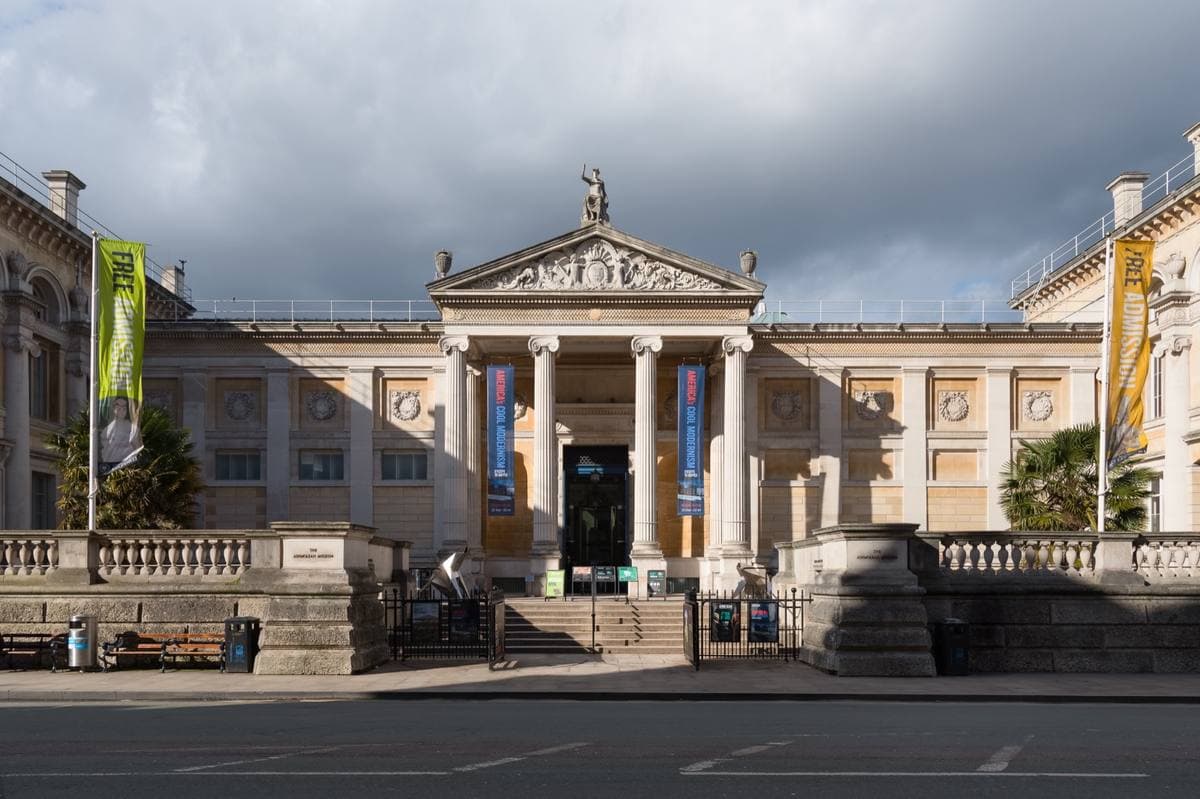 A classical museum front with columns and banners