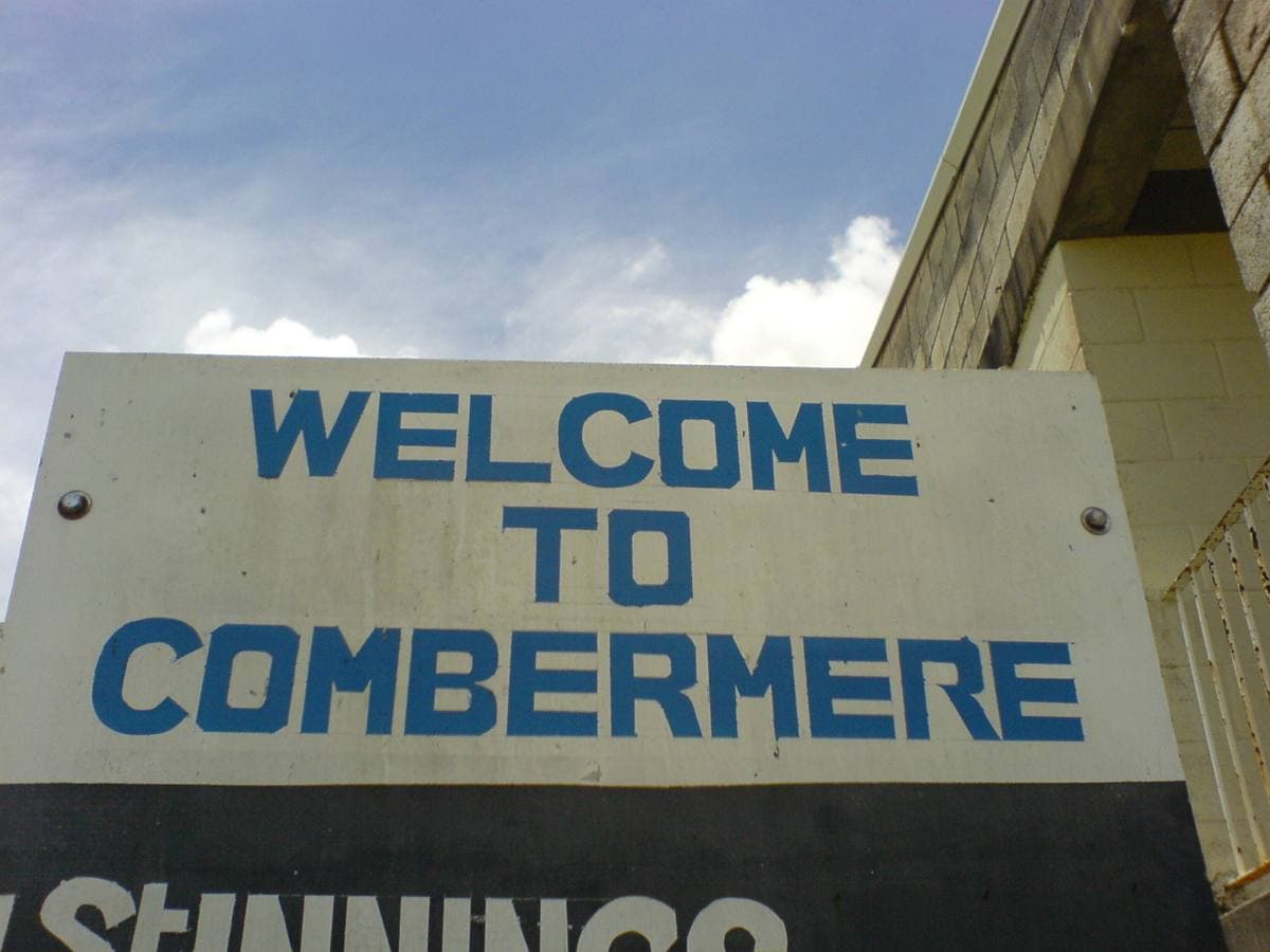 A Welcome to Combermere sign above the scoreboard at the school cricket ground
