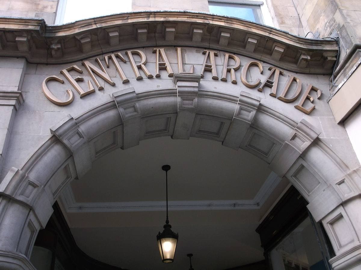 The carved stone entrance arch of Central Arcade with its name over the door