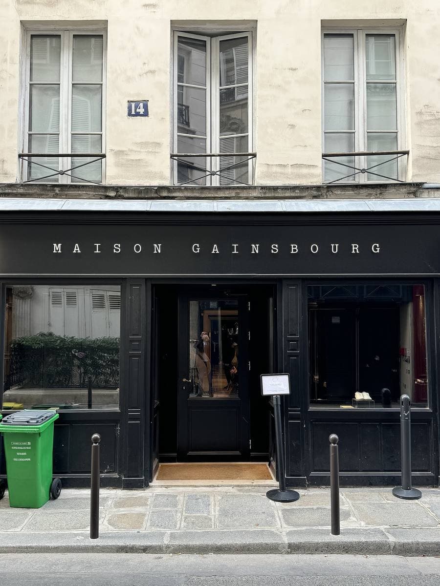 A black shopfront with MAISON GAINSBOURG in small capitals above the door, number 14 on the wall