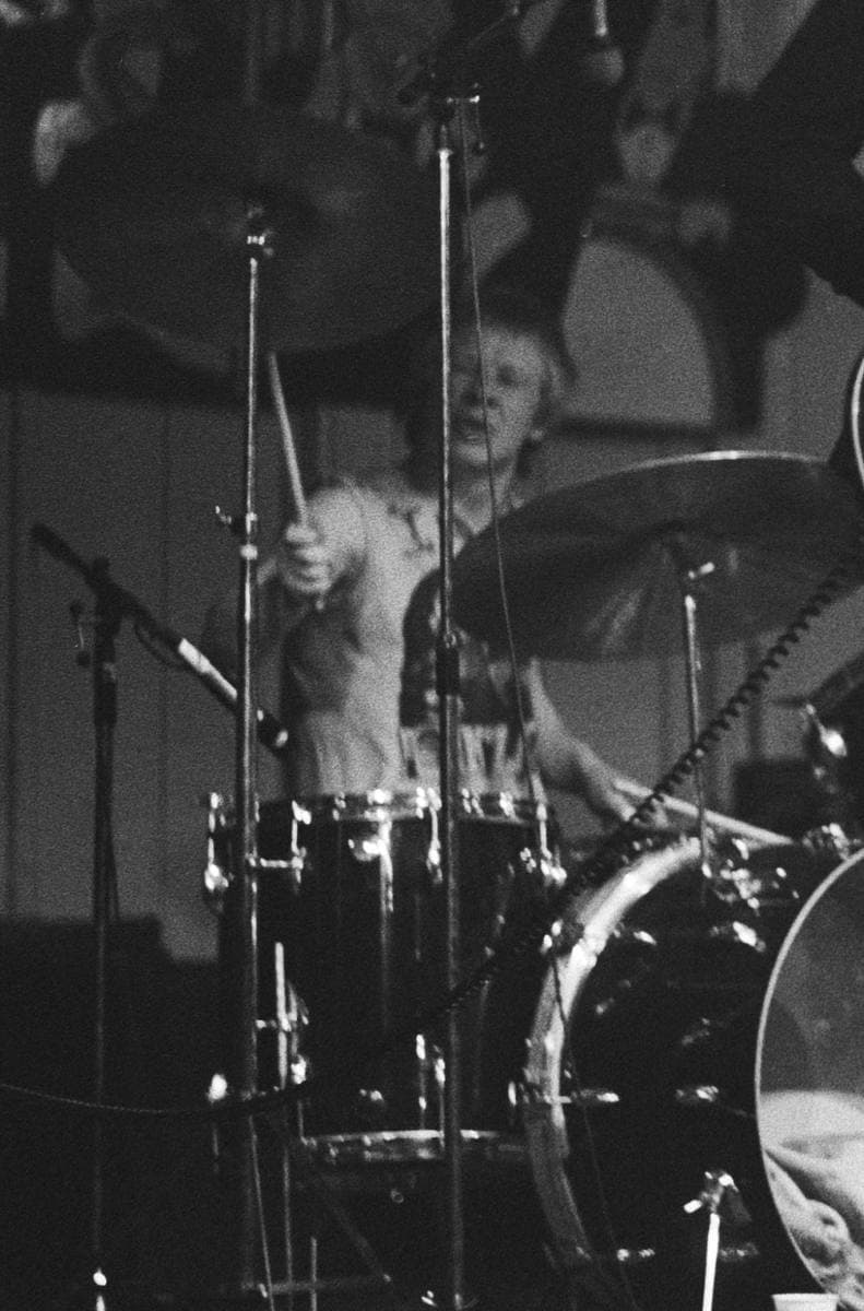 Paul Cook behind his drum kit, black and white