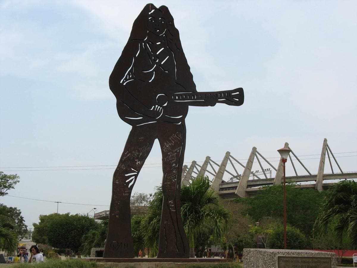 A large metal sculpture of Shakira in a park
