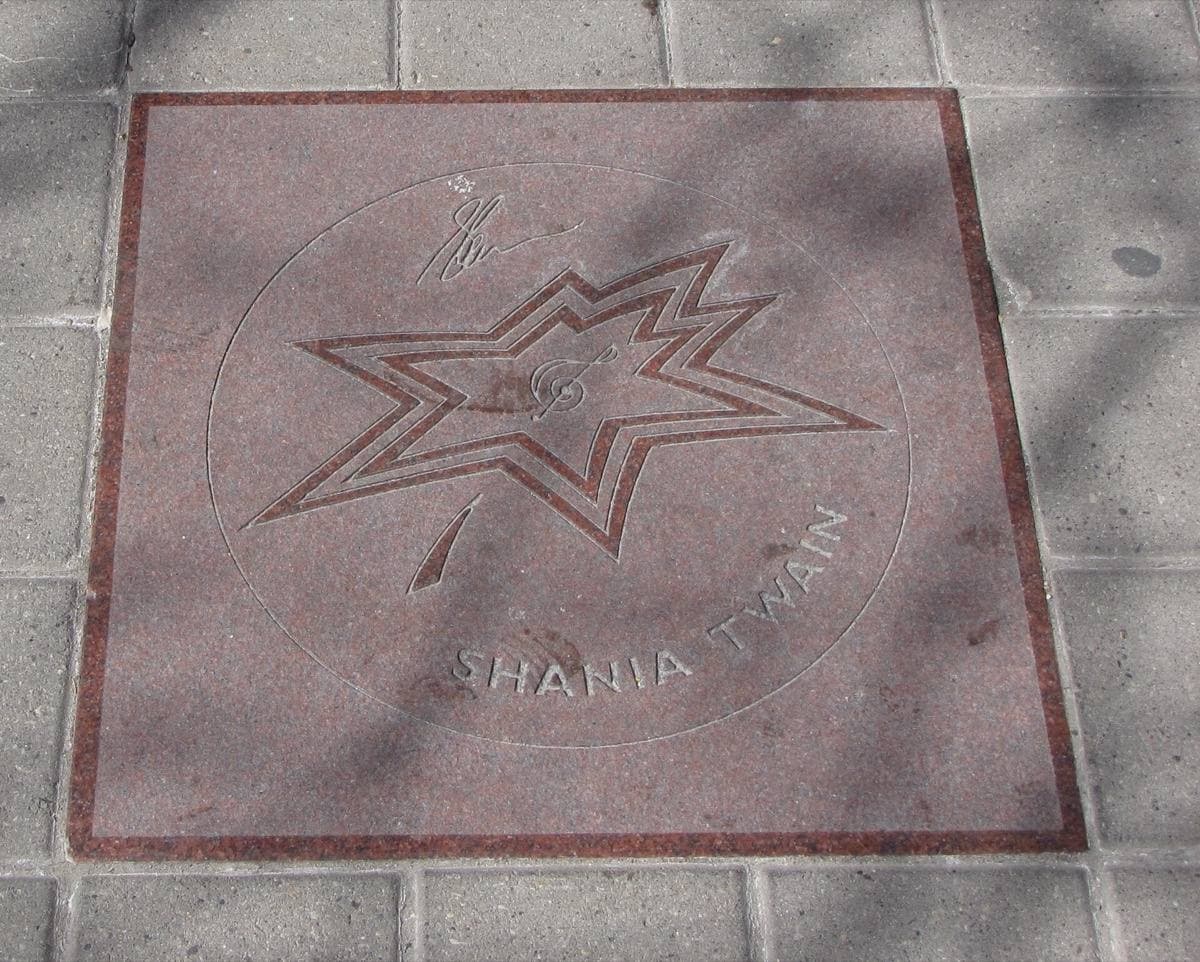 A maple-leaf plaque set in the pavement bearing Shania Twain’s name