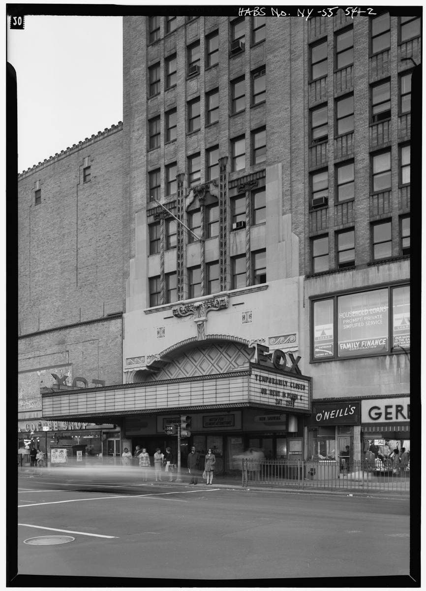 The ornate entrance of a large old theatre on a Brooklyn corner
