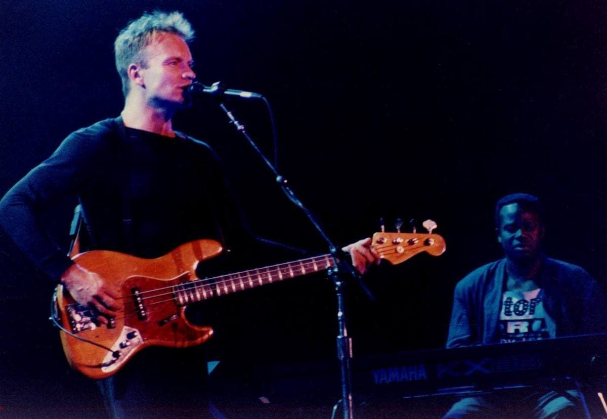 Sting on a large outdoor stage in Madrid, lit by stage lights