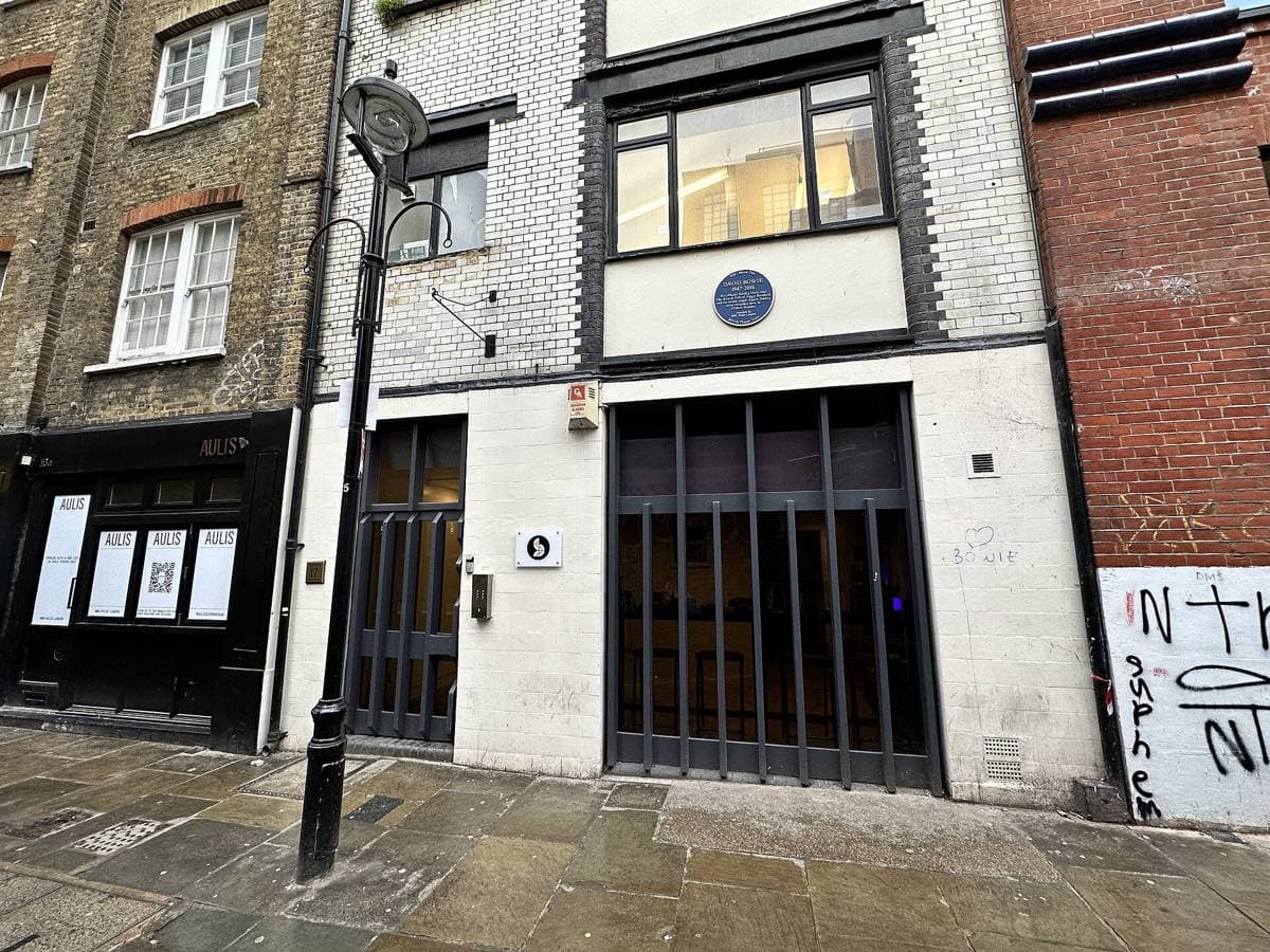 A narrow brick building front in a Soho alley