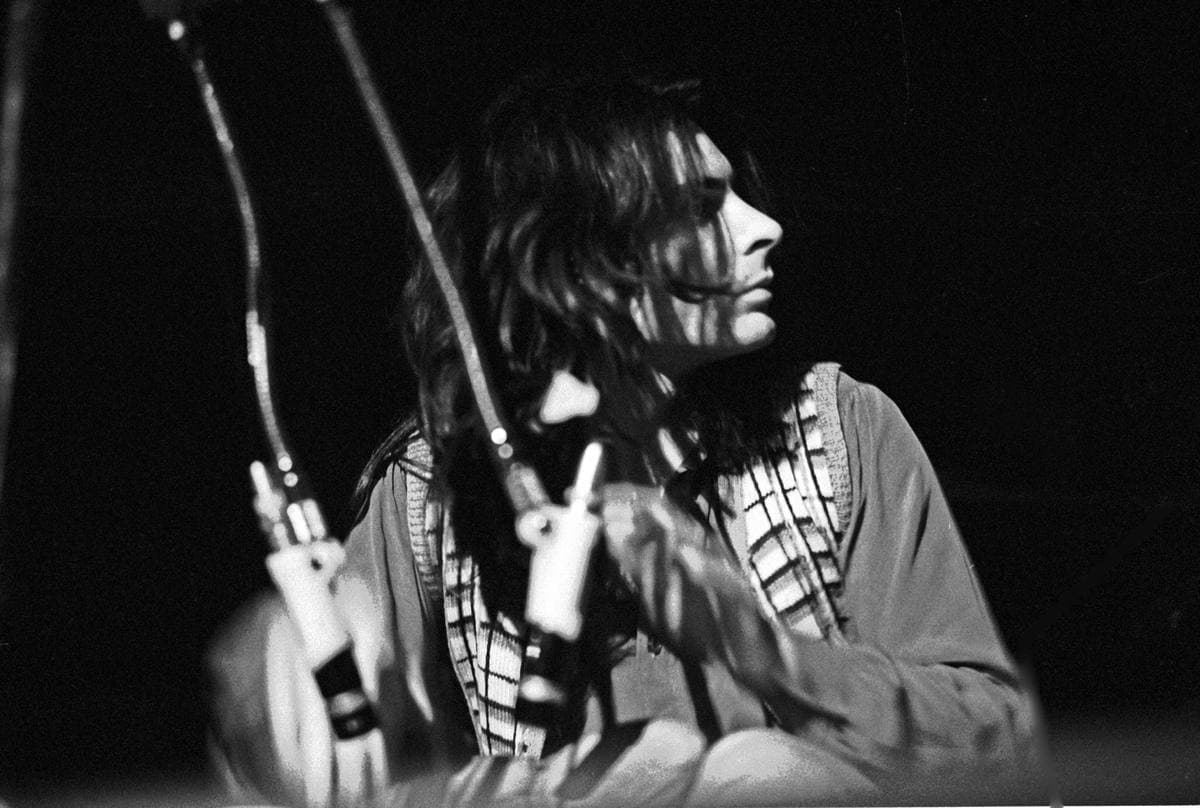 Mickey Finn at a microphone on a dark stage