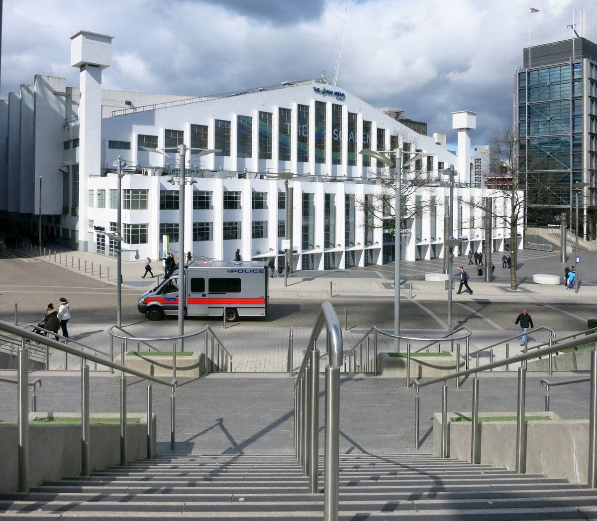 A long white arena with tall fins, steps leading down to it