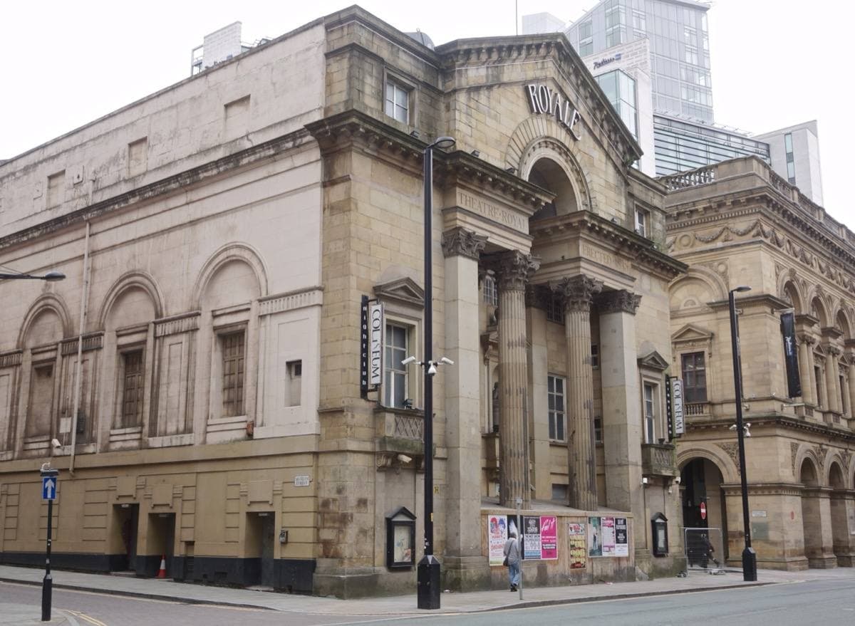 A stone theatre front with tall columns and ROYALE carved in the pediment