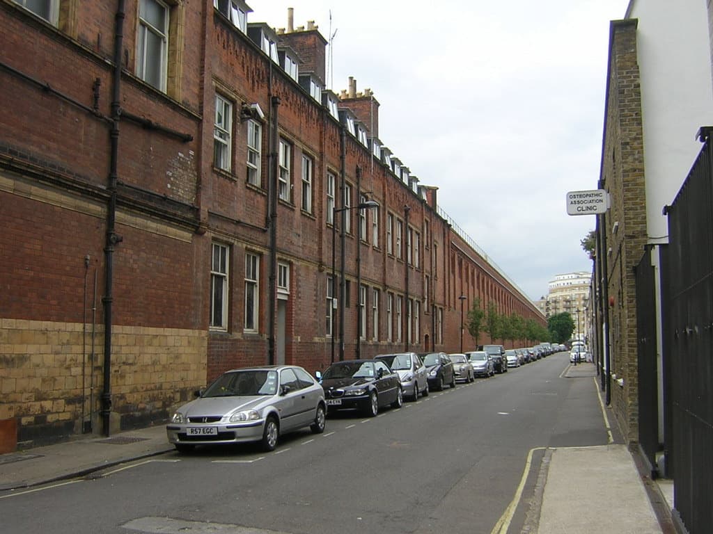 A narrow street alongside a station wall