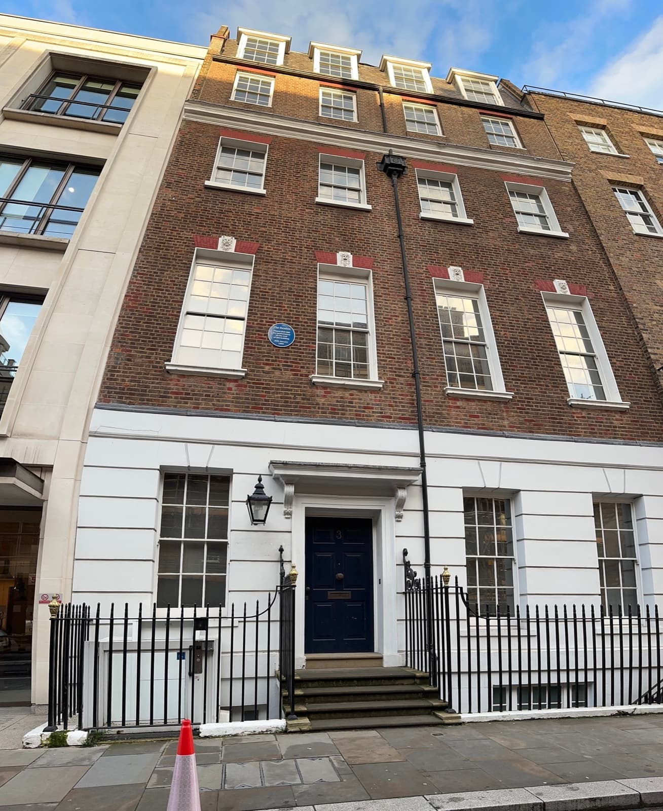 A Georgian brick townhouse with a blue plaque