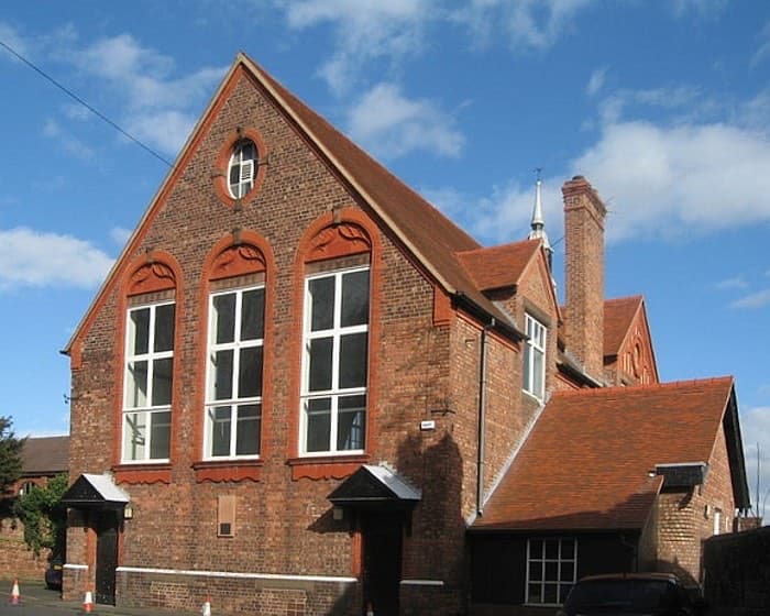 A sandstone church hall on a quiet road