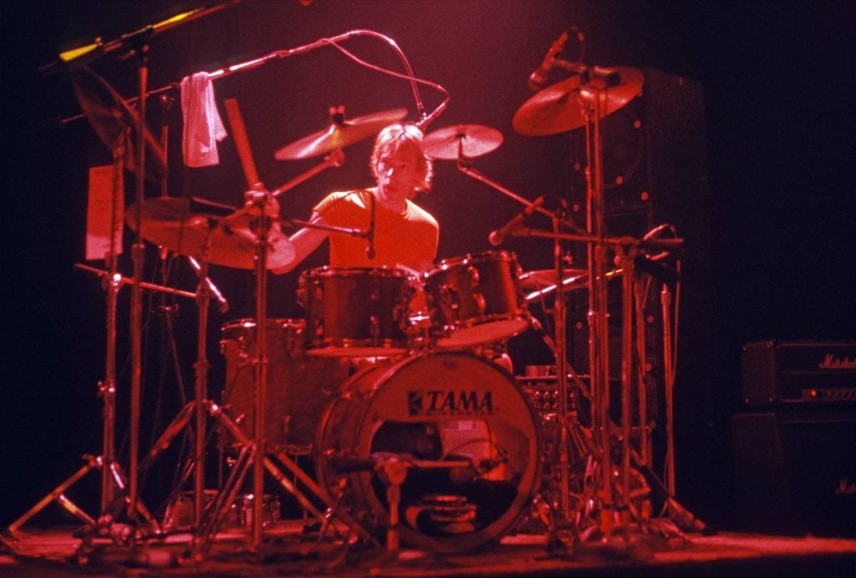Stewart Copeland at his drum kit under red light