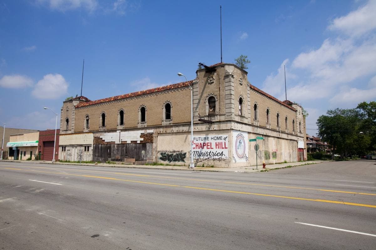 A long empty two-storey brick ballroom building on a wide avenue