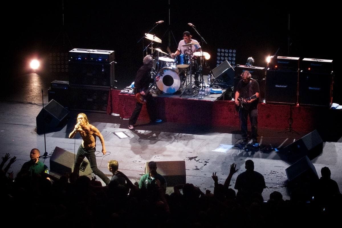 The band under stage lights in a London theatre