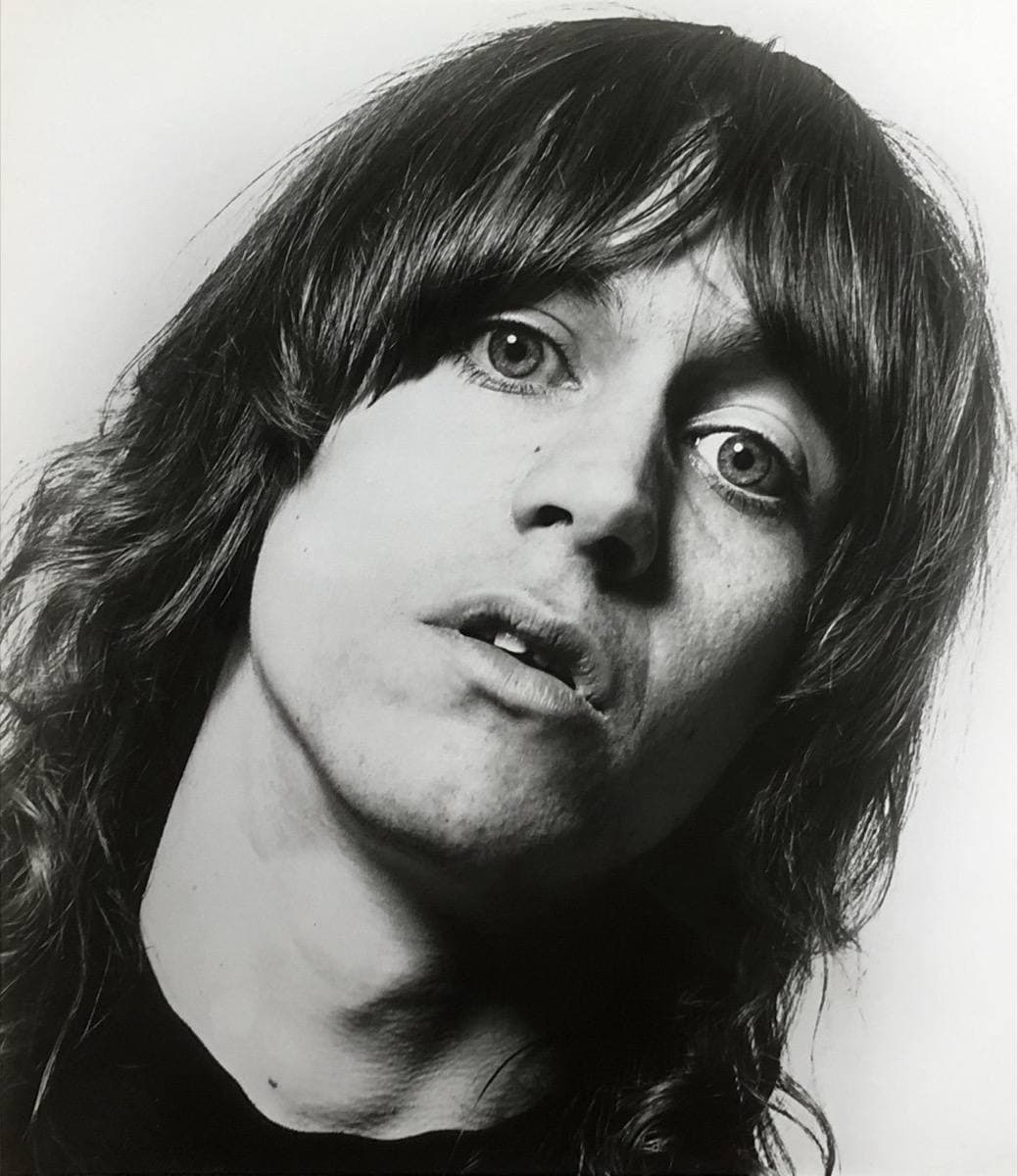 A close black-and-white portrait of the young singer with long straight hair