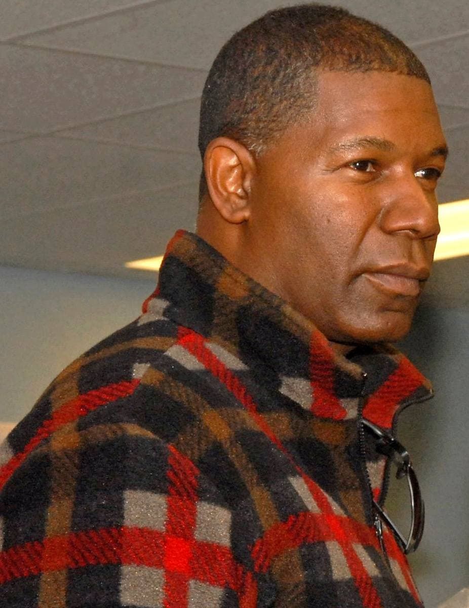 Dennis Haysbert smiling, in a cap