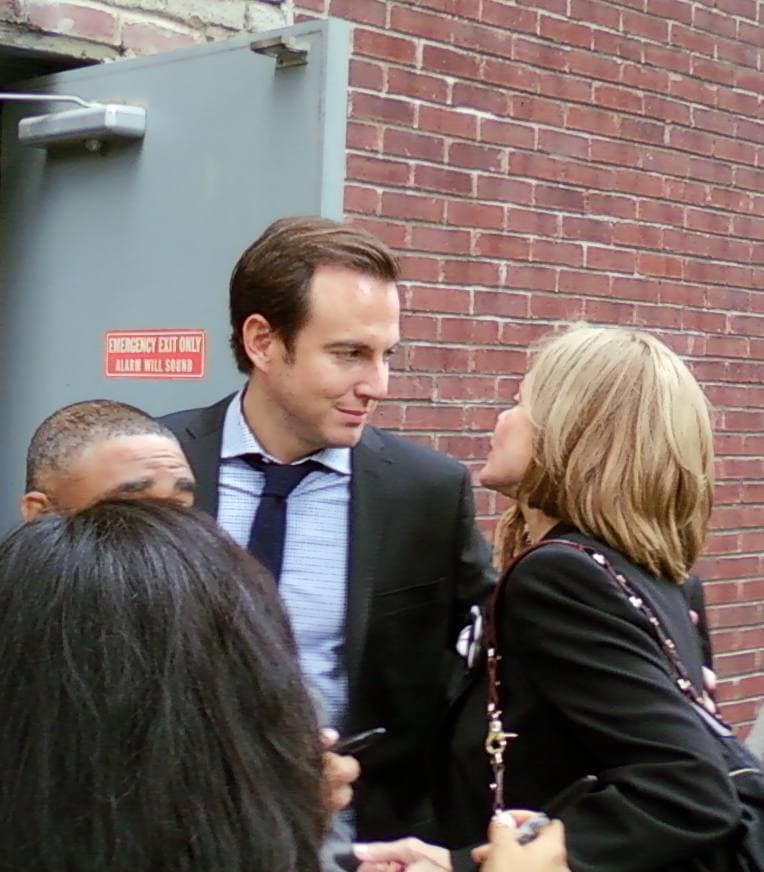 Will Arnett on stage holding a microphone