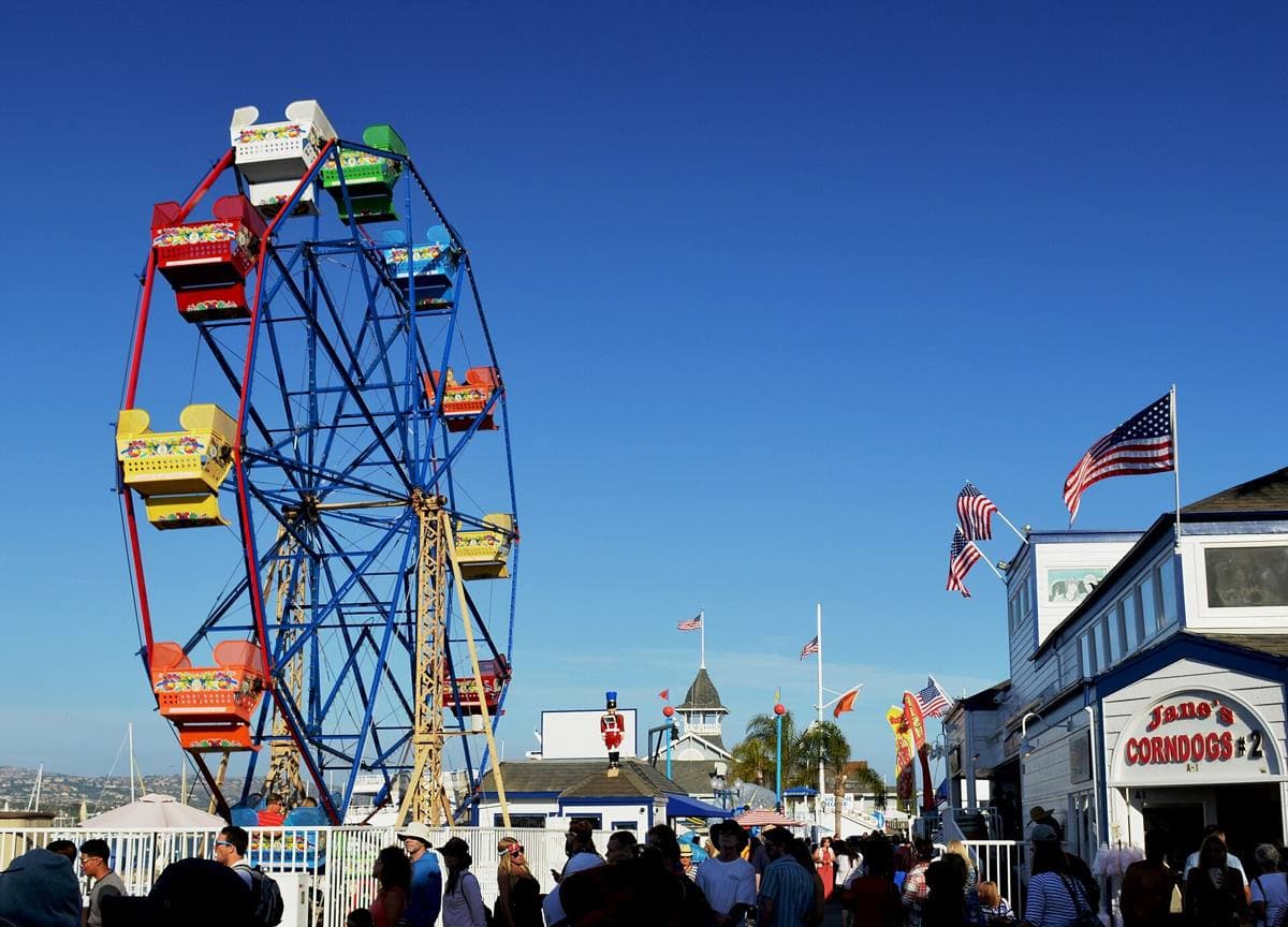The Ferris wheel and boardwalk of the Balboa Fun Zone by the harbour