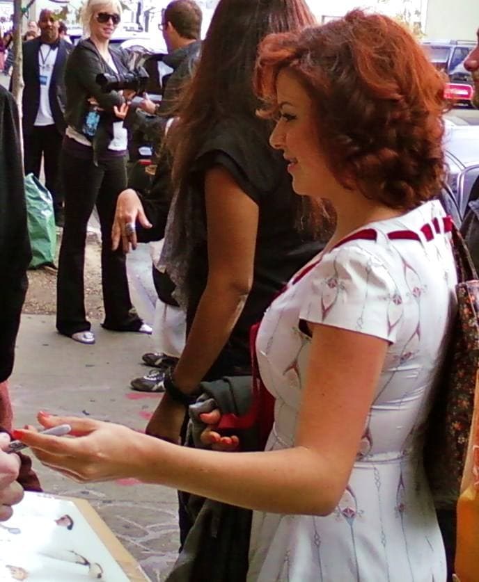 Alia Shawkat seated on stage, smiling