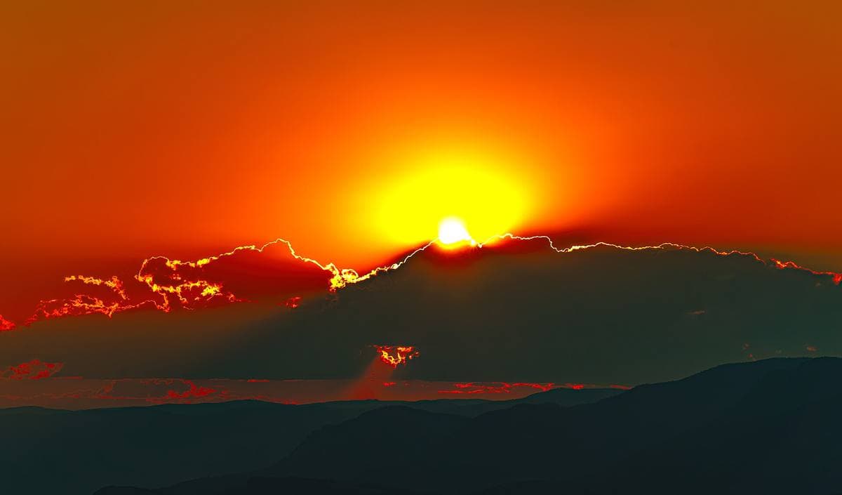 Dry hills and a river valley at sunset