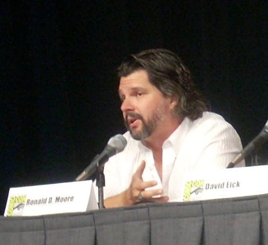A man in glasses speaking into a microphone