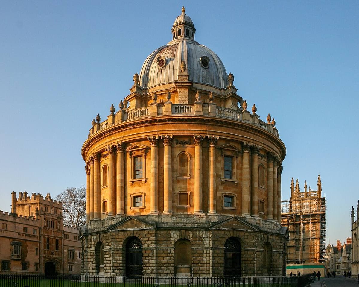 A round domed library building in a stone square