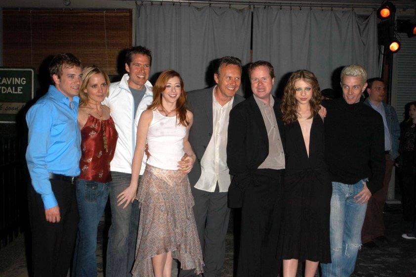 A group of the Buffy cast posing together at a party, James Marsters among them