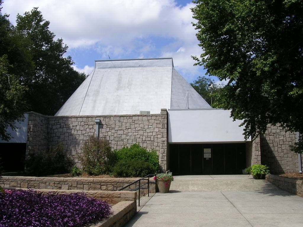 A modernist building entrance among trees
