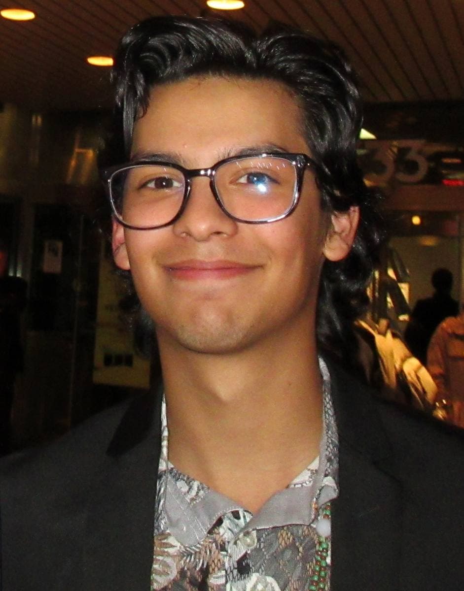 Xolo Maridueña in a dark jacket at an evening event
