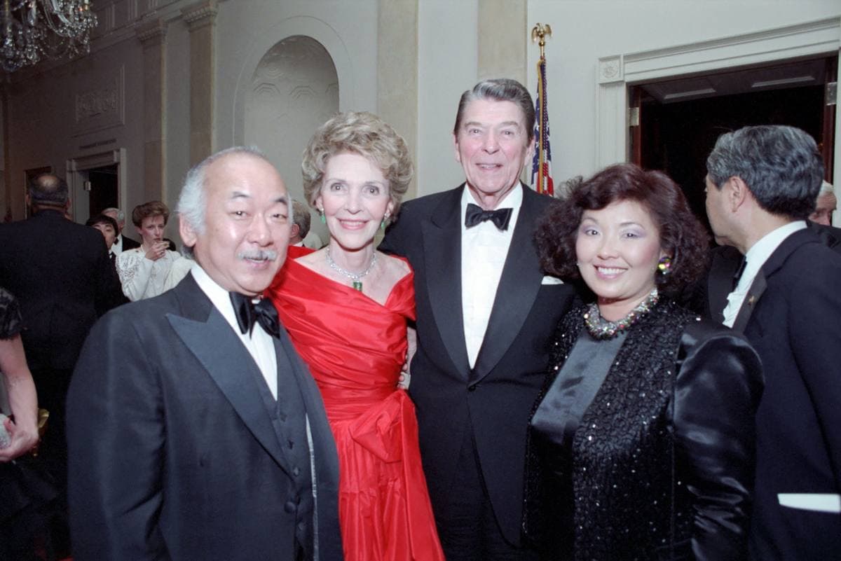 Pat Morita in evening dress with his wife and the Reagans in the White House Cross Hall
