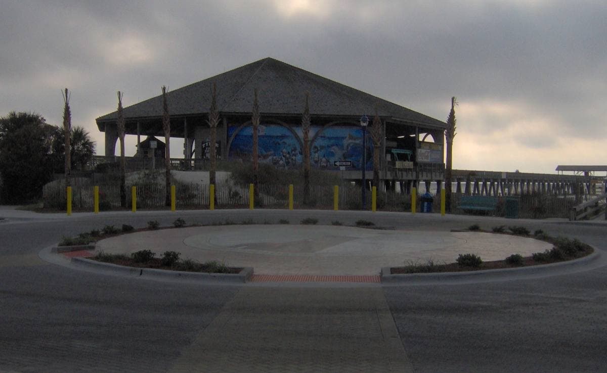 A long pier with a pavilion running out over the Atlantic from a beach