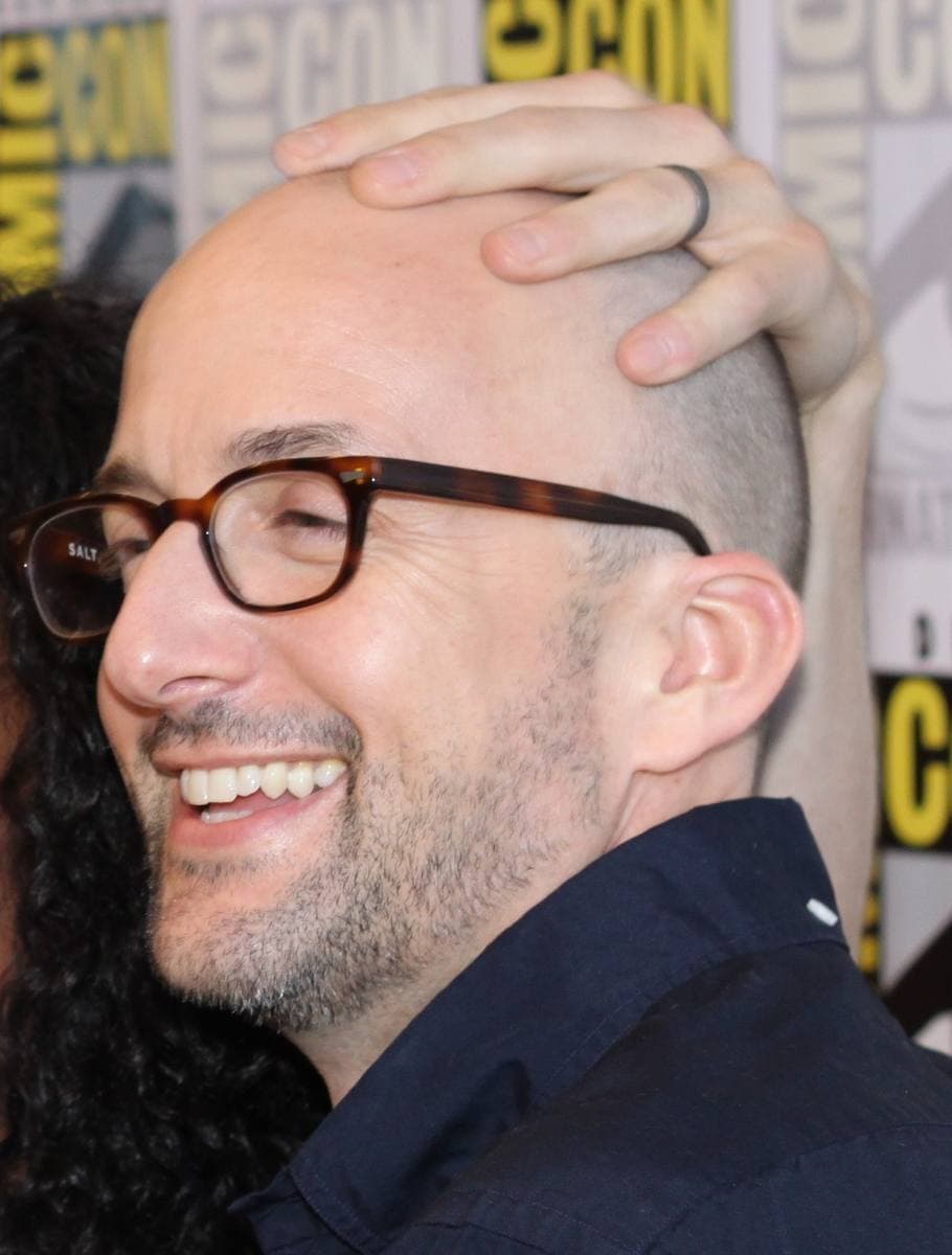 A smiling man with glasses at a convention