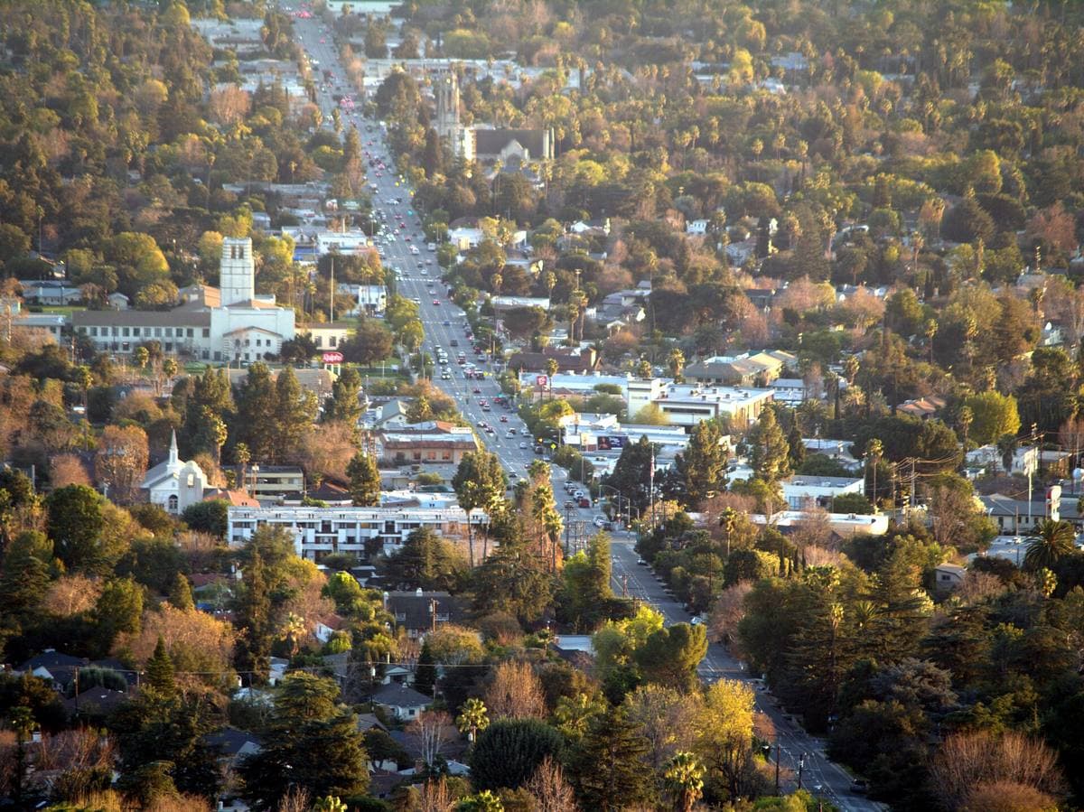 A wide avenue running towards mountains