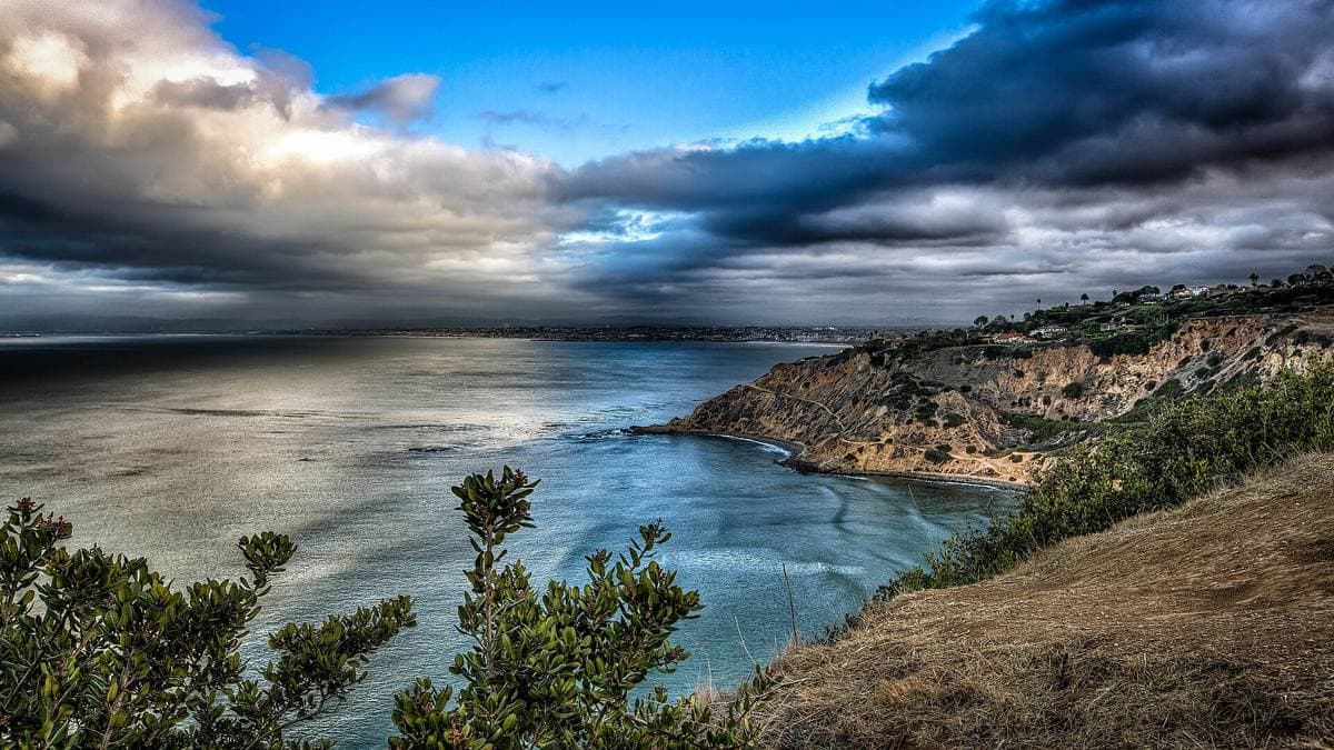 Green bluffs falling to a calm blue sea