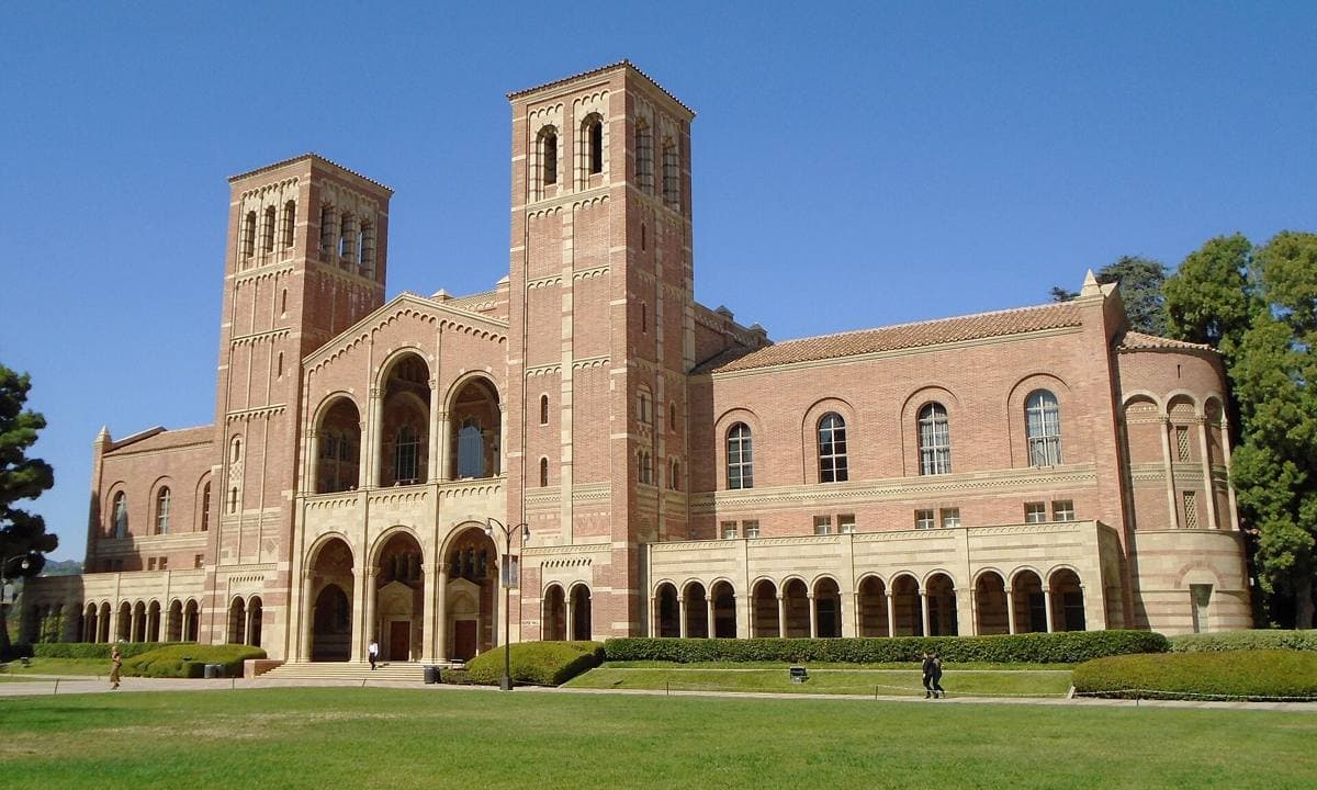 A red-brick Romanesque hall with two towers