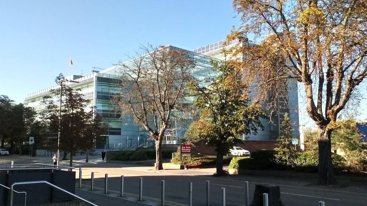 A long modern office block of glass and pale panels