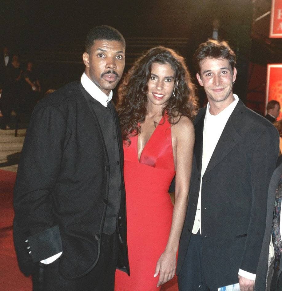 Eriq La Salle and Noah Wyle on a red carpet in 1995 with a woman in a red dress between them