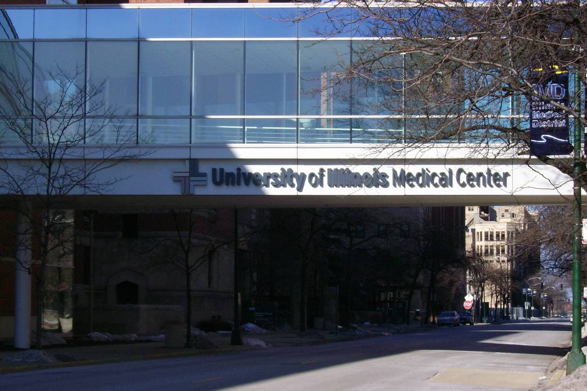 A glass skybridge marked University of Illinois Medical Center over a street