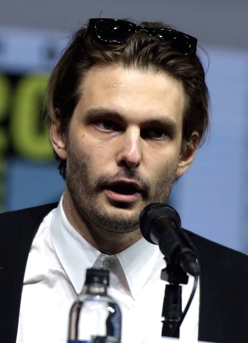 Sam Levinson speaking into a microphone on a panel