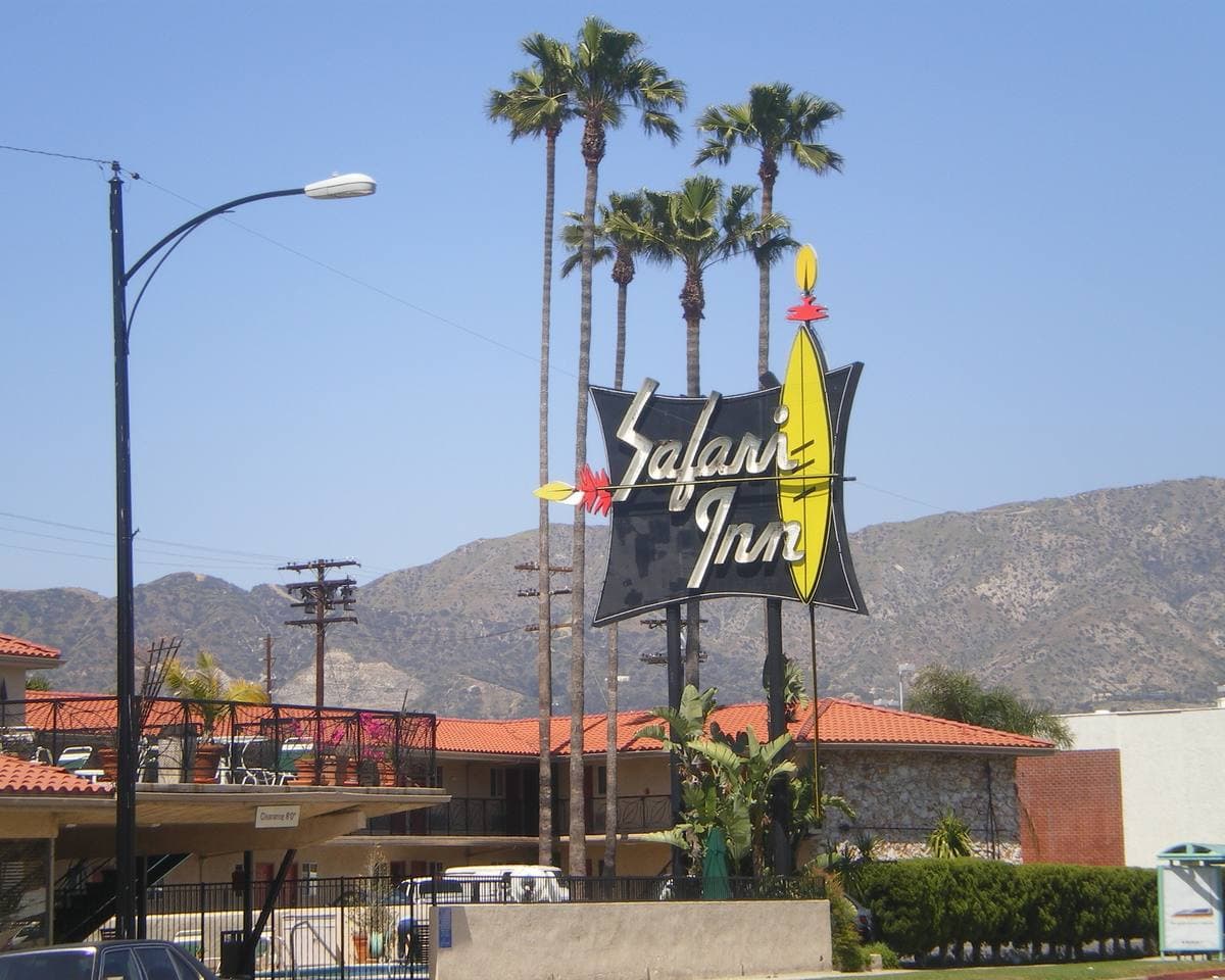 A 1950s motel sign on a palm-lined avenue in Burbank